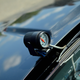 A lone fuel pressure gauge mounted to the hood of a buick GNX